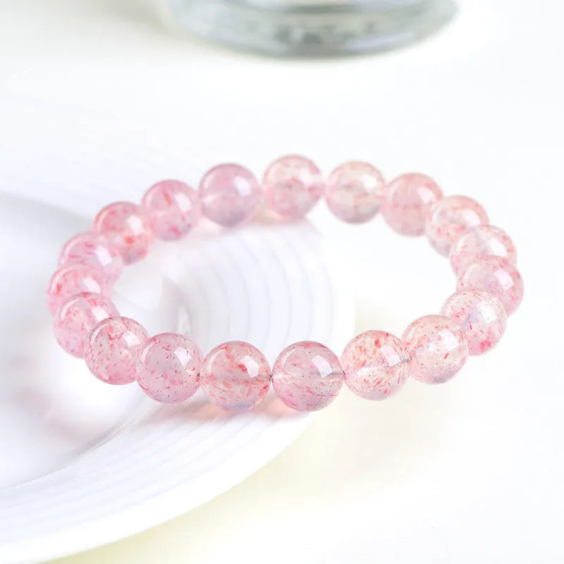 Strawberry quartz crystal bracelet with 10-10.8mm white water geometry beads on wrist