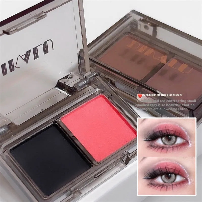 Cool two-tone eye shadow plate showing pink and black matte shimmer colours in a standard cosmetic compact.