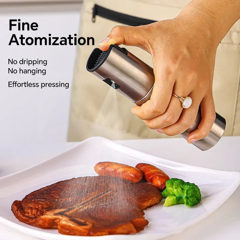 Stainless steel press spray oil injection bottle with glass body and 100ml capacity on kitchen countertop