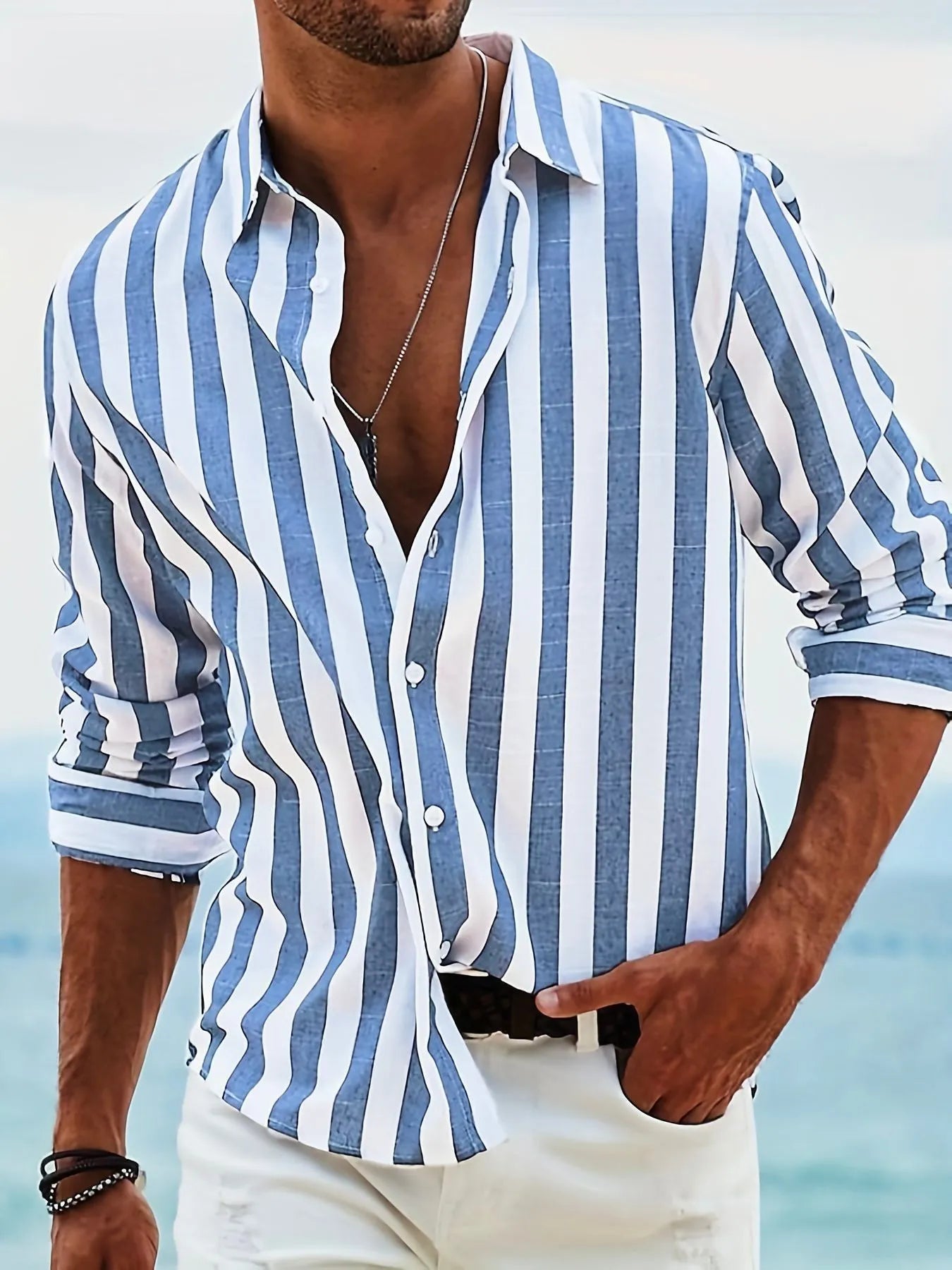 Man wearing a loose-fit yarn-dyed striped long-sleeved casual shirt in light grey.