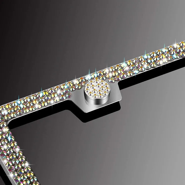 White diamond-studded stainless steel licence plate frame on a car showing 160x310mm external size