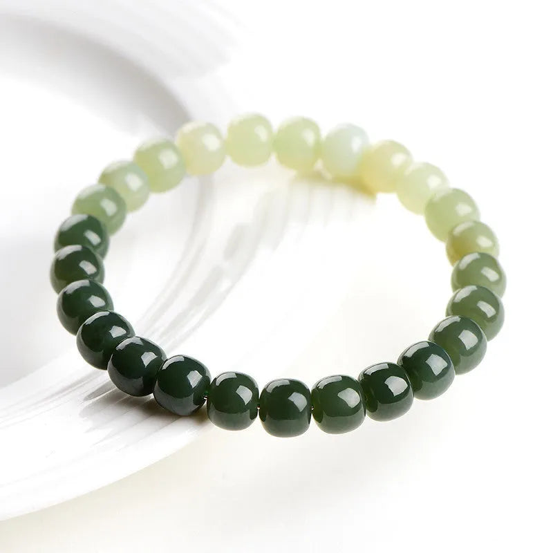Natural Hetian jade bracelet with water gradient colour on polished beads.