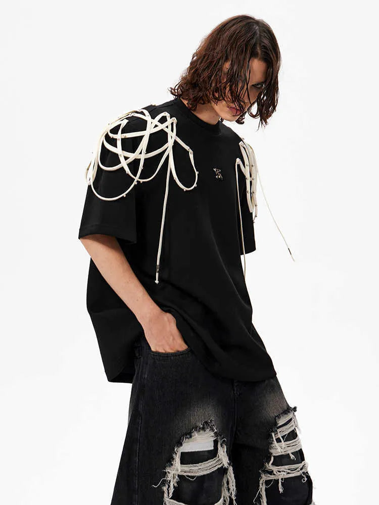 Black loose fit T-shirt with padded shoulders featuring rivet ribbon detailing, short sleeves and round neck collar