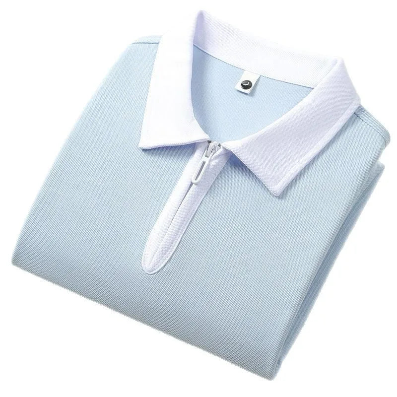 Man's solid colour polo shirt with a front zipper and lapel collar, shown in a loose fit.