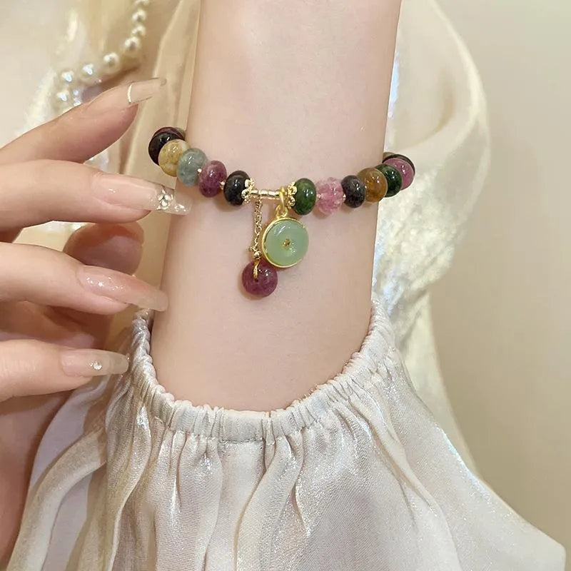 Colourful tourmaline rabbit pendant on a natural stone abacus bead bracelet.