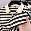 Men's black lapel jacquard stripes short-sleeve shirt on a hanger, showing asymmetrical design.