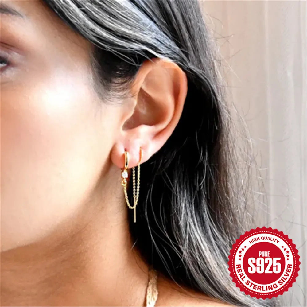 S925 sterling silver ear stud with geometric diamond flower, tassel, and chain design in a gold colour.