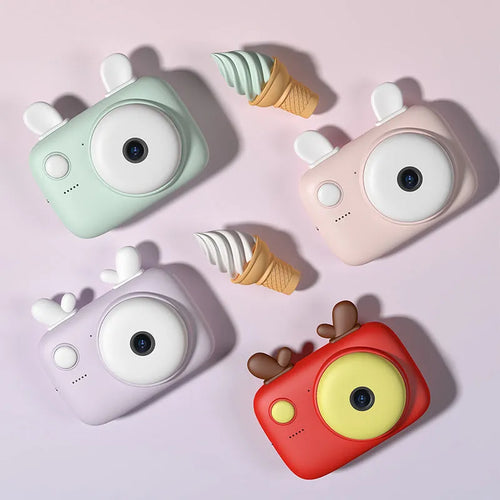 A2 Kids Macaron Mini SLR digital camera in pink, showing front and rear lenses and 2.4-inch screen.