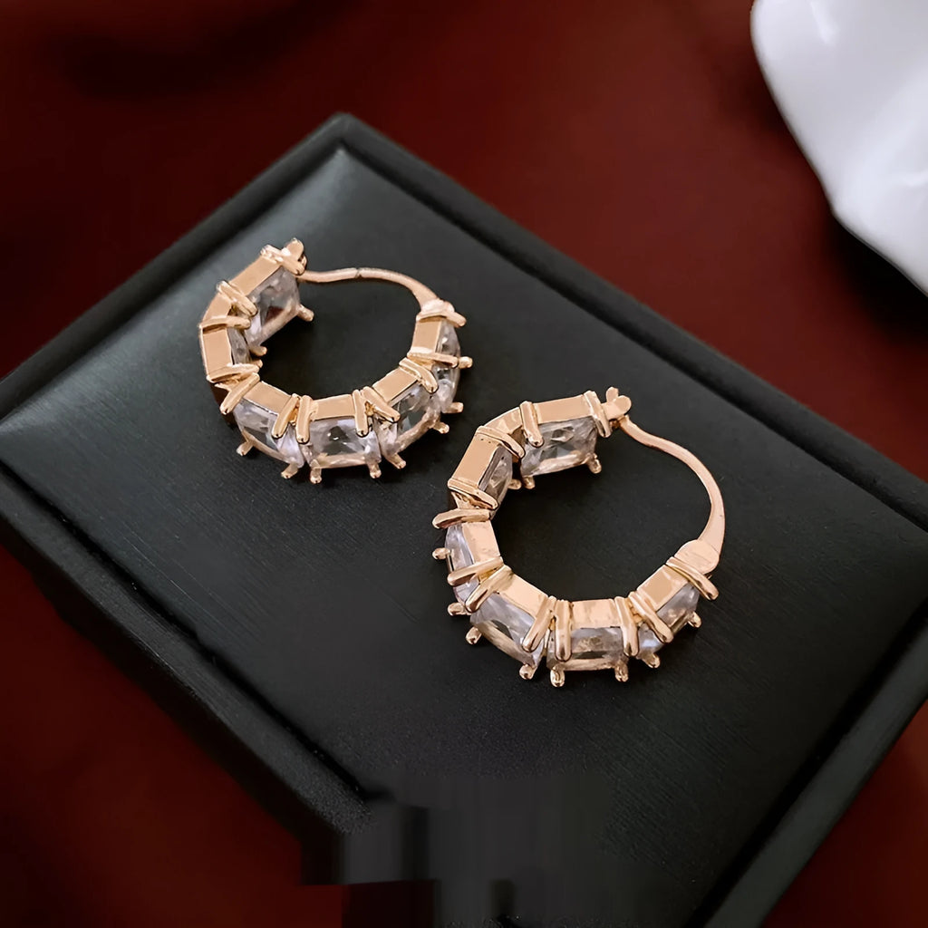 Gold-coloured U-shaped copper earrings with micro-inlaid zircon stones, geometric quadrilateral design, clip-on style.