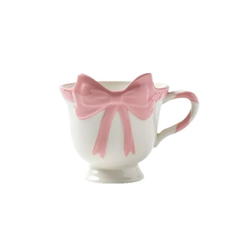 Ceramic mug with heart bow design in white powder and black pink colours.