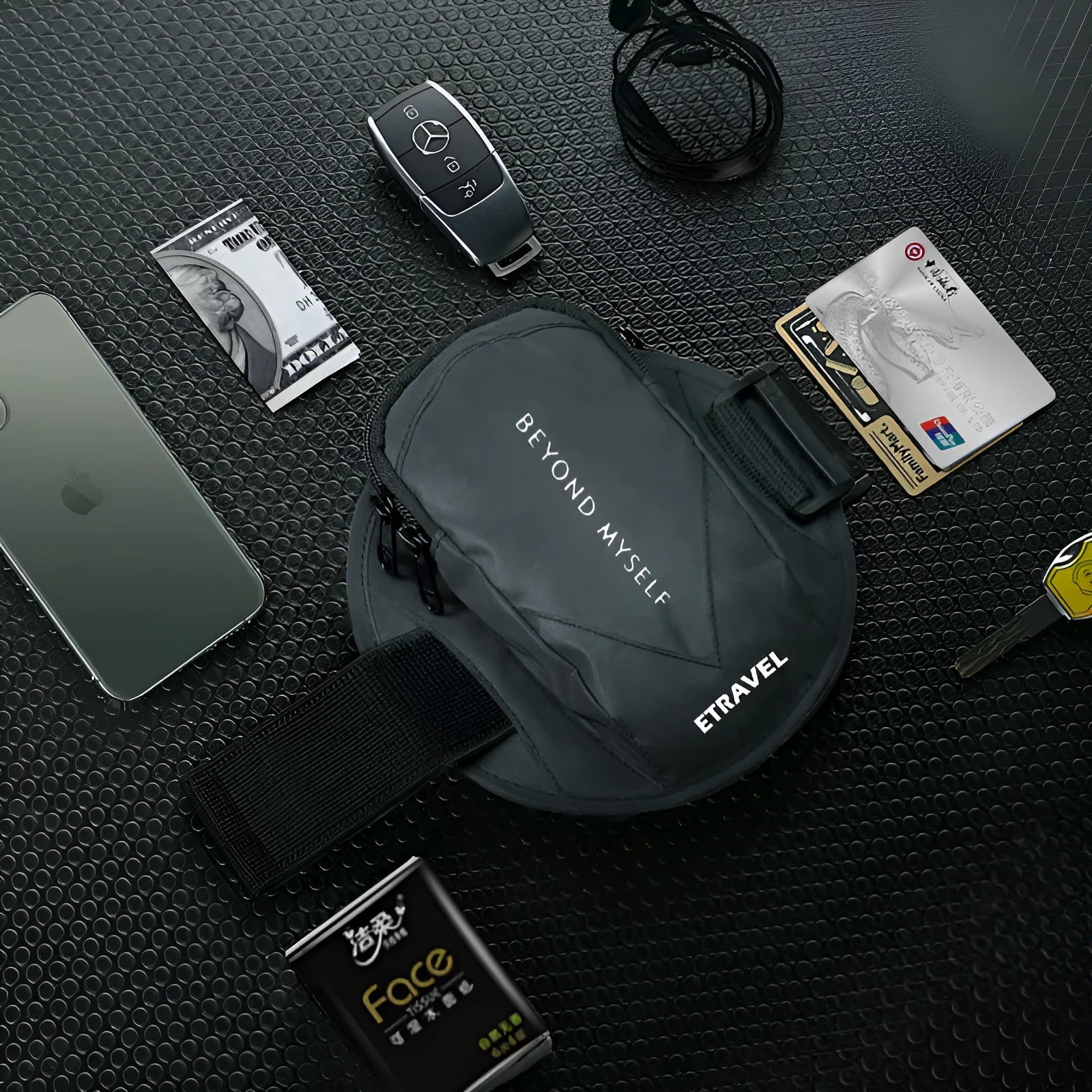 Black reflective running arm bag with adjustable strap, shown holding a large smartphone.