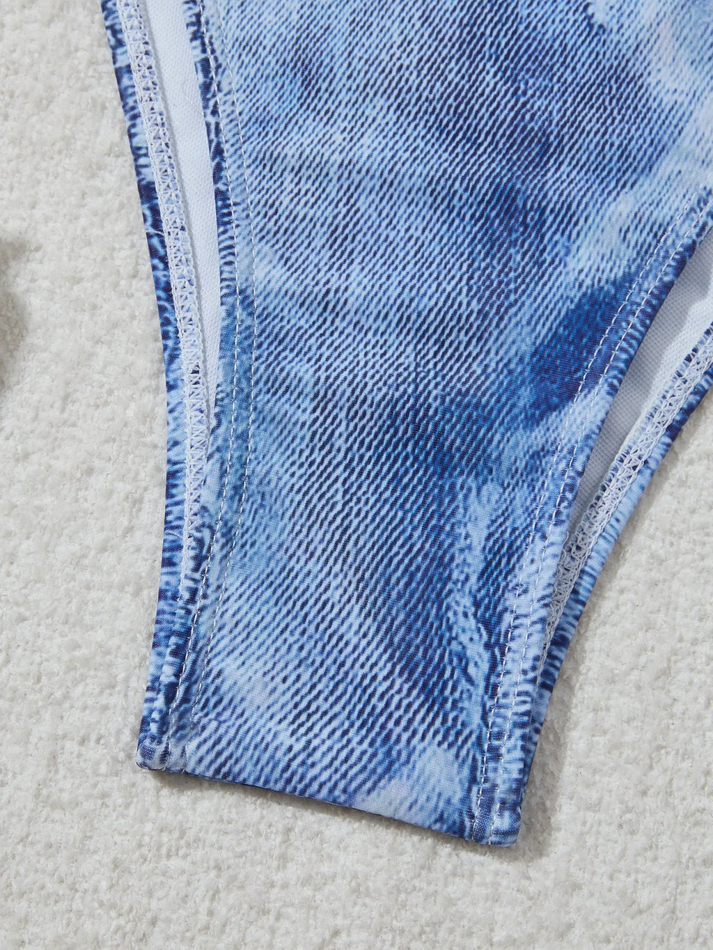 Denim blue printed bikini top and bottom set for women on a mannequin.