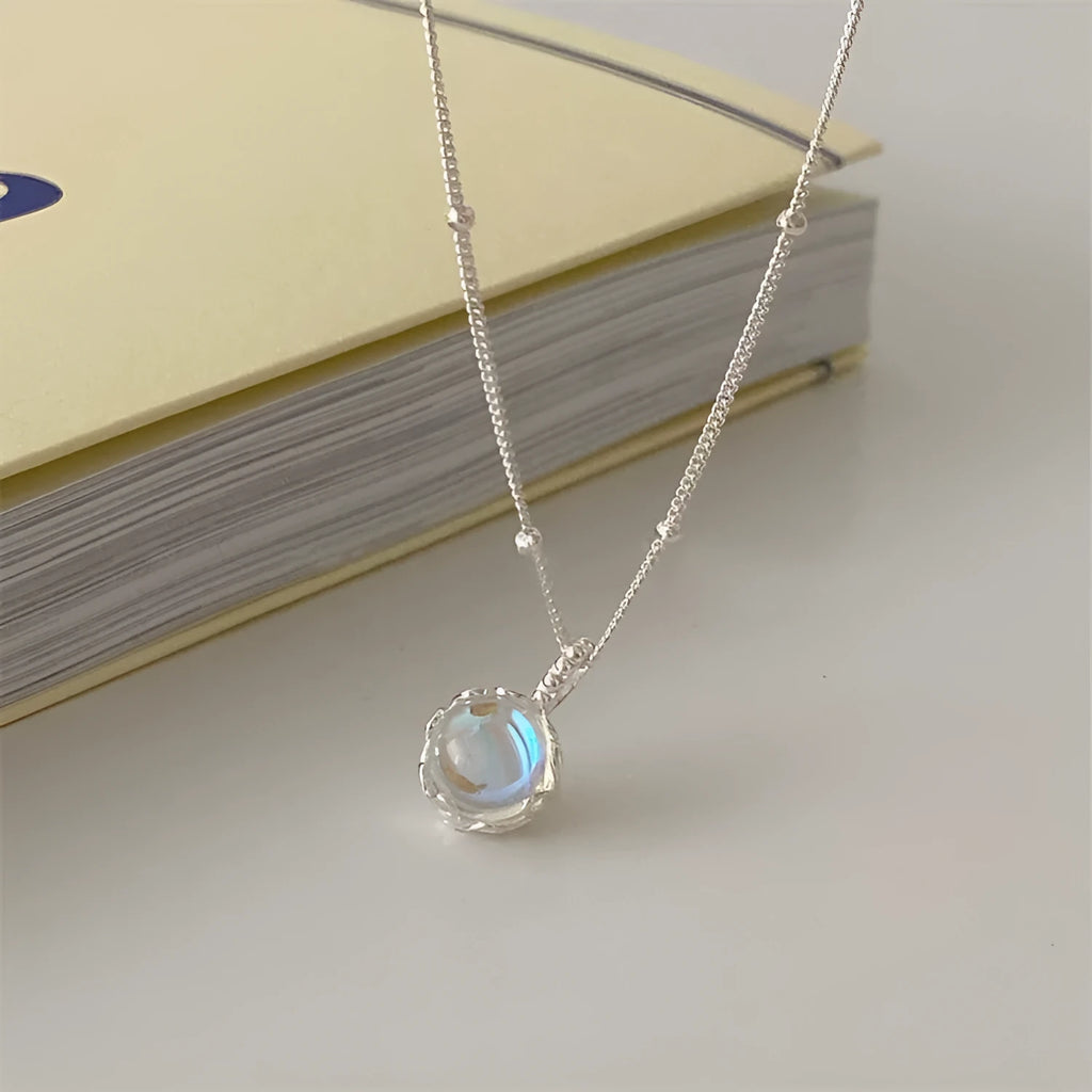 Silver geometric pendant necklace on a curb chain with adjustable length 41-50cm.