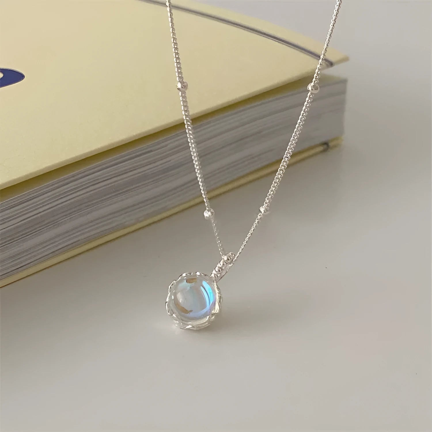 Silver geometric pendant necklace on a curb chain with adjustable length 41-50cm.