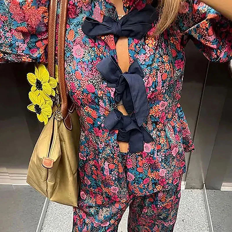Women's floral print trousers suit with puff sleeves and tie-neck design in picture colour