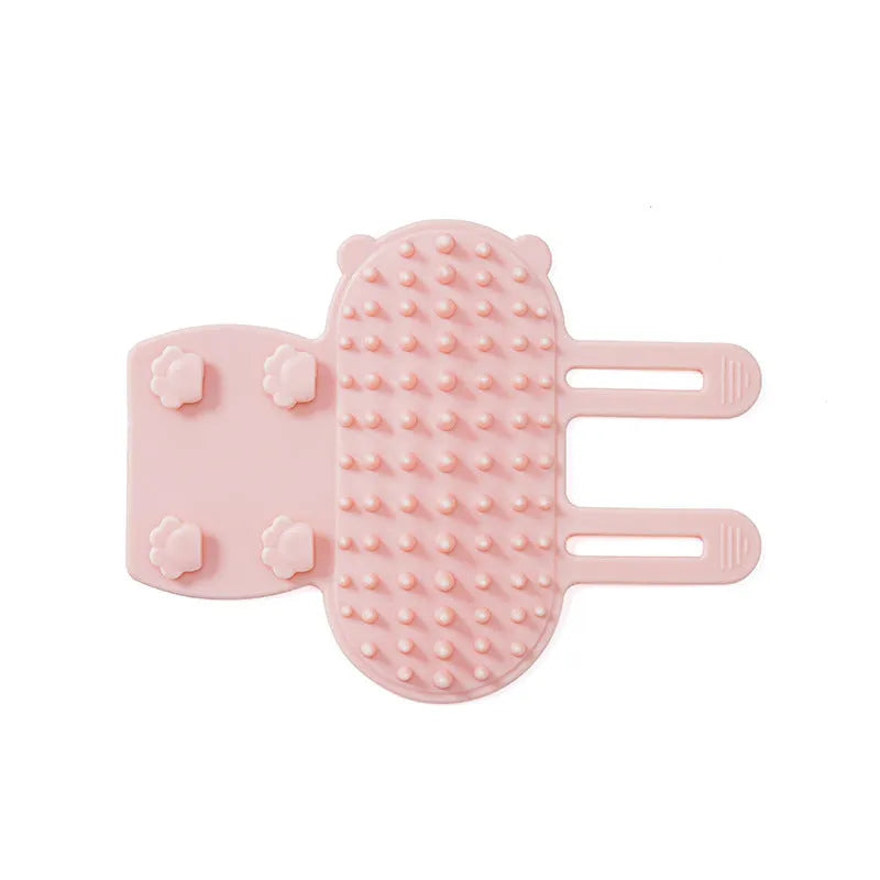 Silicone cat grooming comb with rounded teeth and adjustable strap mounted on a table leg.
