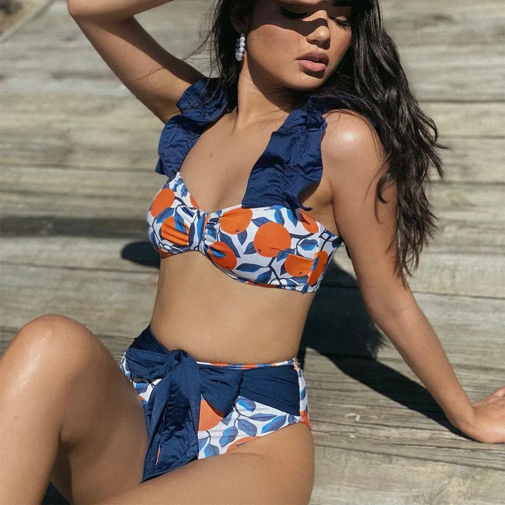 Women's blue and orange printed high waist bikini swimsuit two-piece set on a white background
