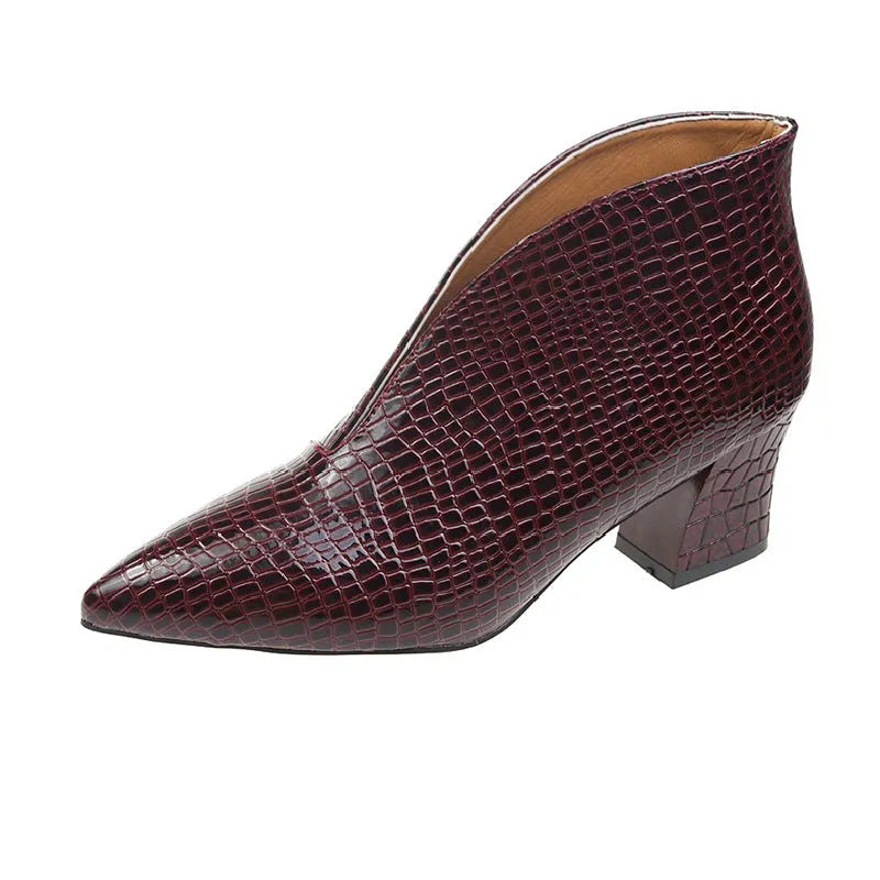 Women's black embossed V-cut Martin boots with a chunky heel on a white background.
