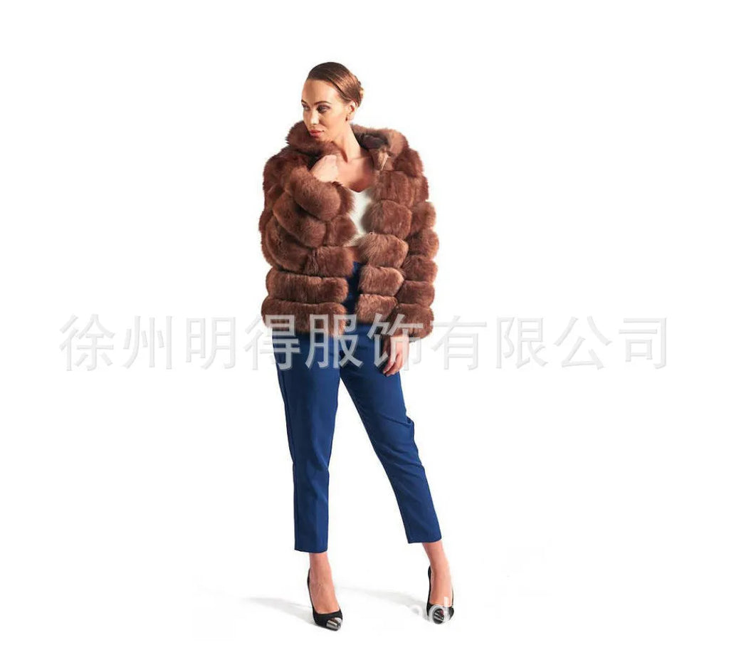 A woman wearing a loose-fitting artificial fur coat with a hood, in a street fashion style.