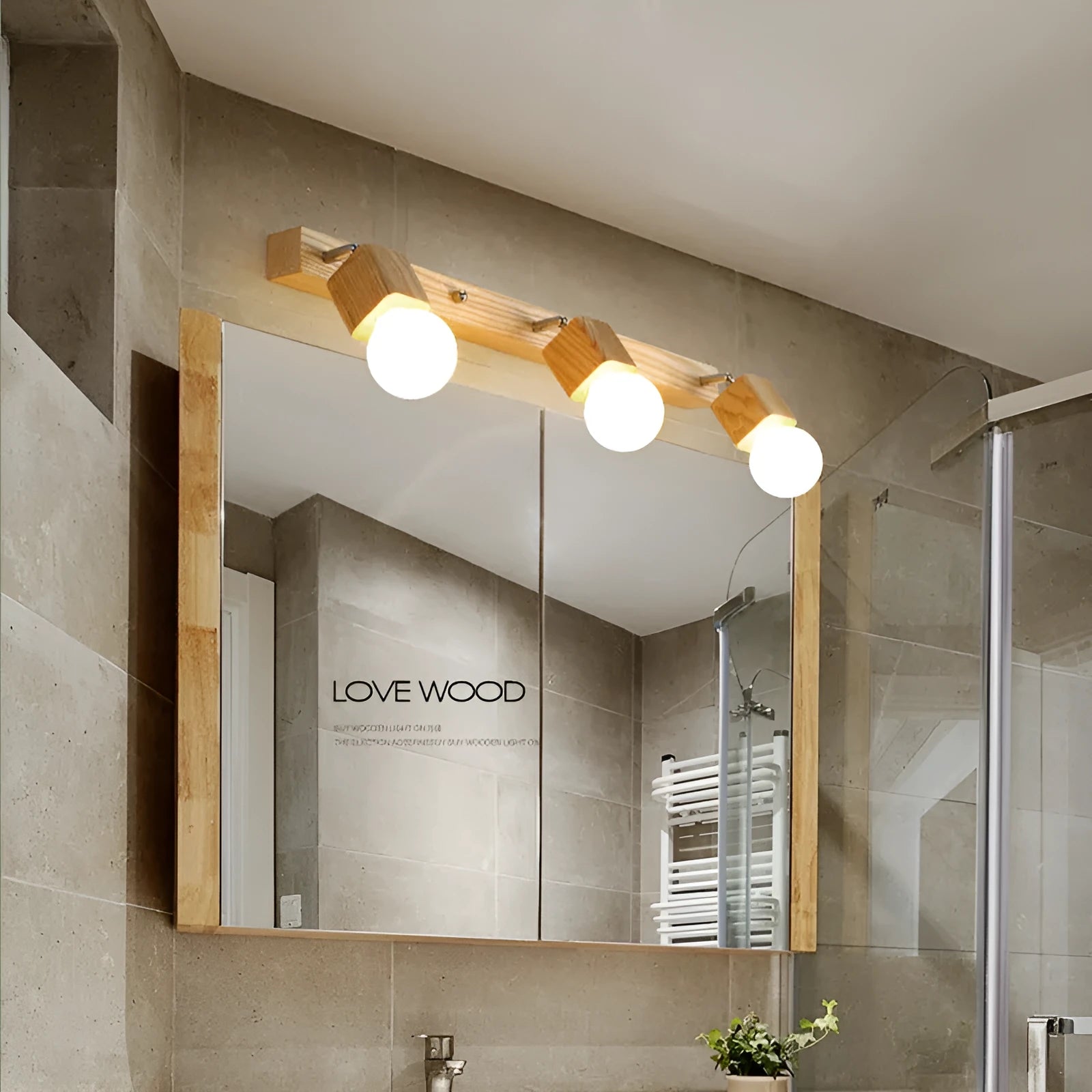 Single head 24cm LED wall lamp mounted beside a mirror.