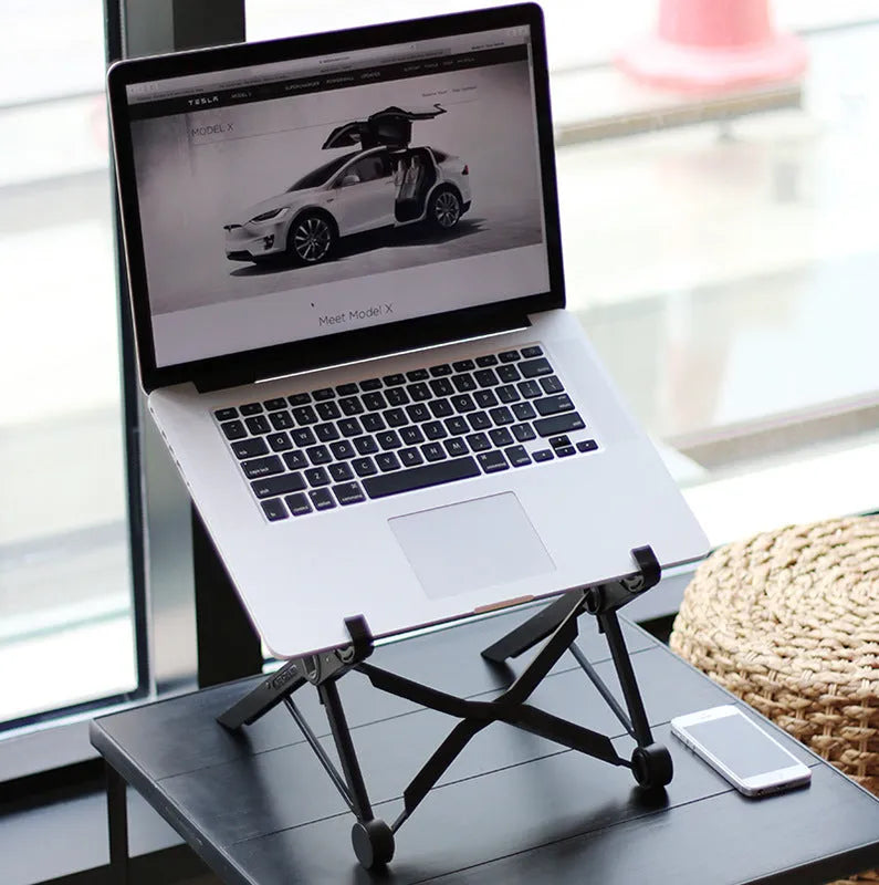 Black foldable portable laptop stand shown with its nylon carry bag and gaskets