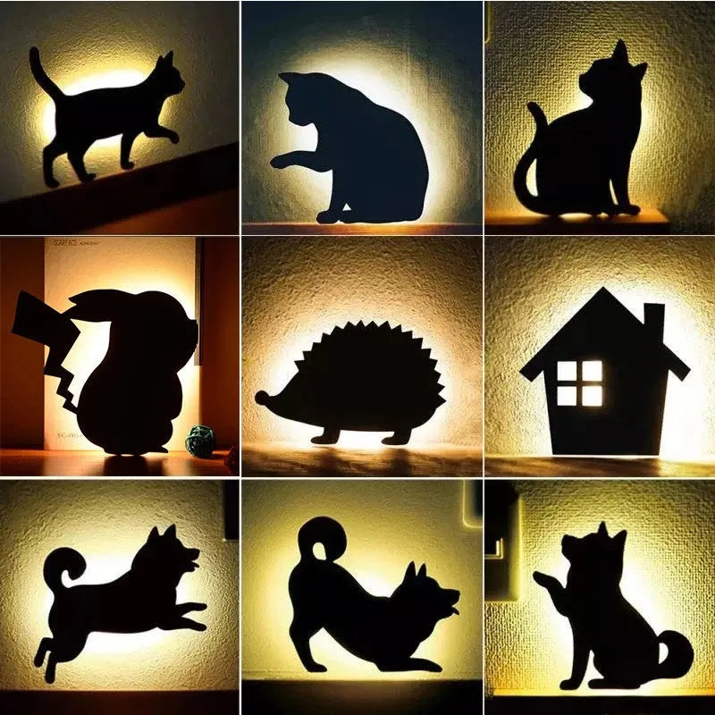 Black cartoon cat shaped LED night light with sound sensor for wall mounting.