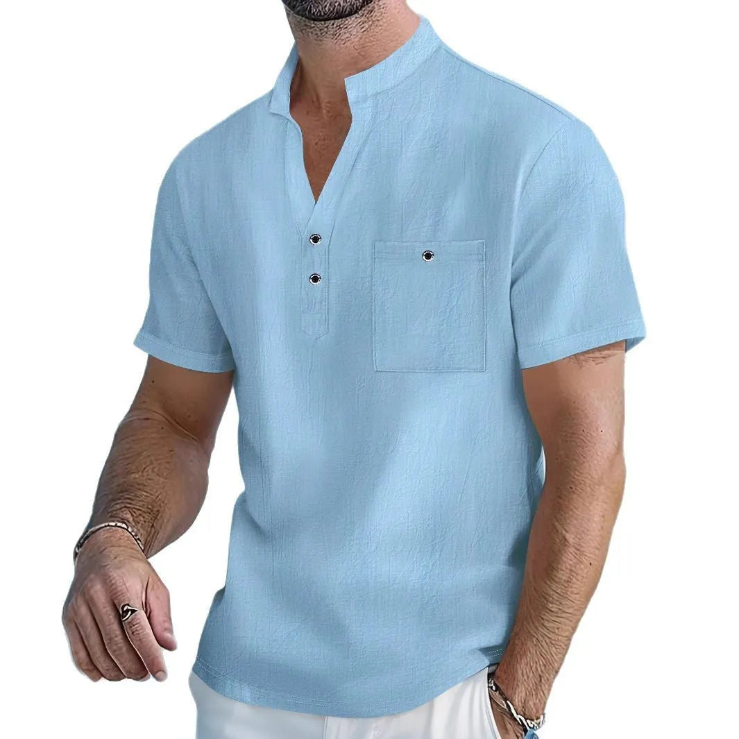 Man wearing a loose apricot-coloured linen stand collar T-shirt with short sleeves.