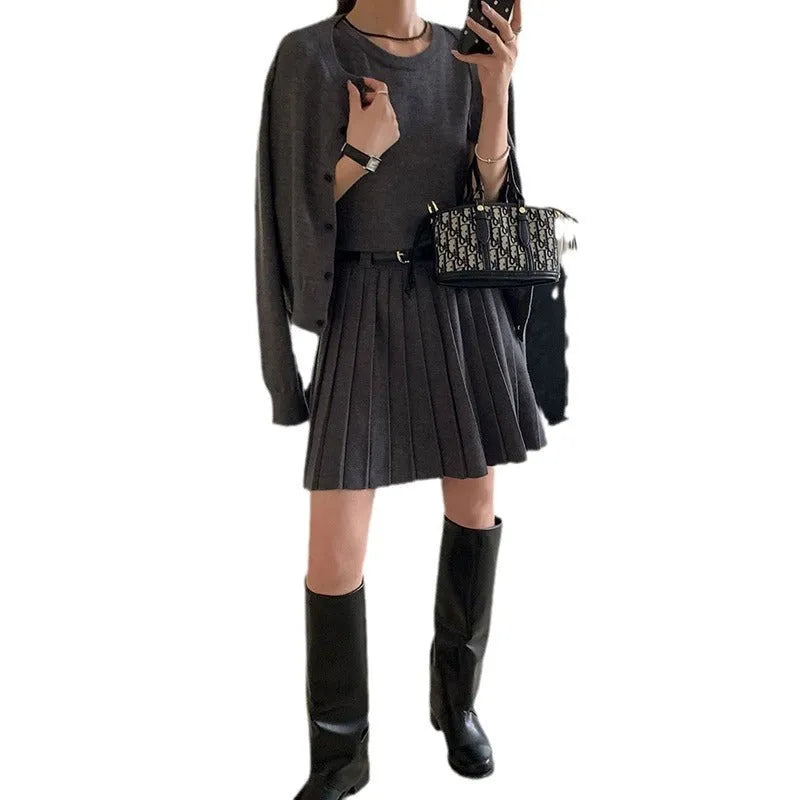 Women's grey knitted vest skirt and long-sleeve cardigan set with 3D pattern and an adjustable waist belt.