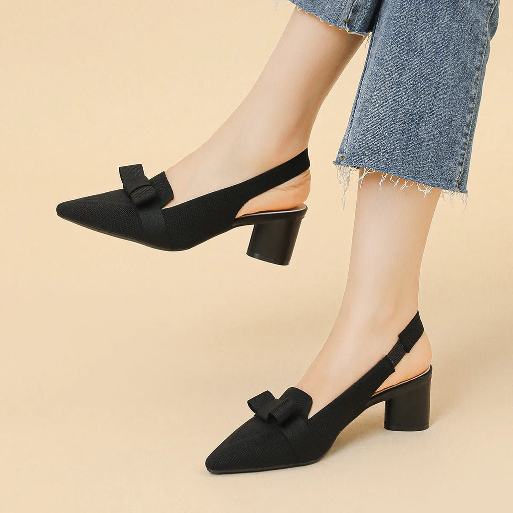 Women's closed toe high heel sandal with back ankle strap in a solid colour, showing pointed toe and fabric upper.