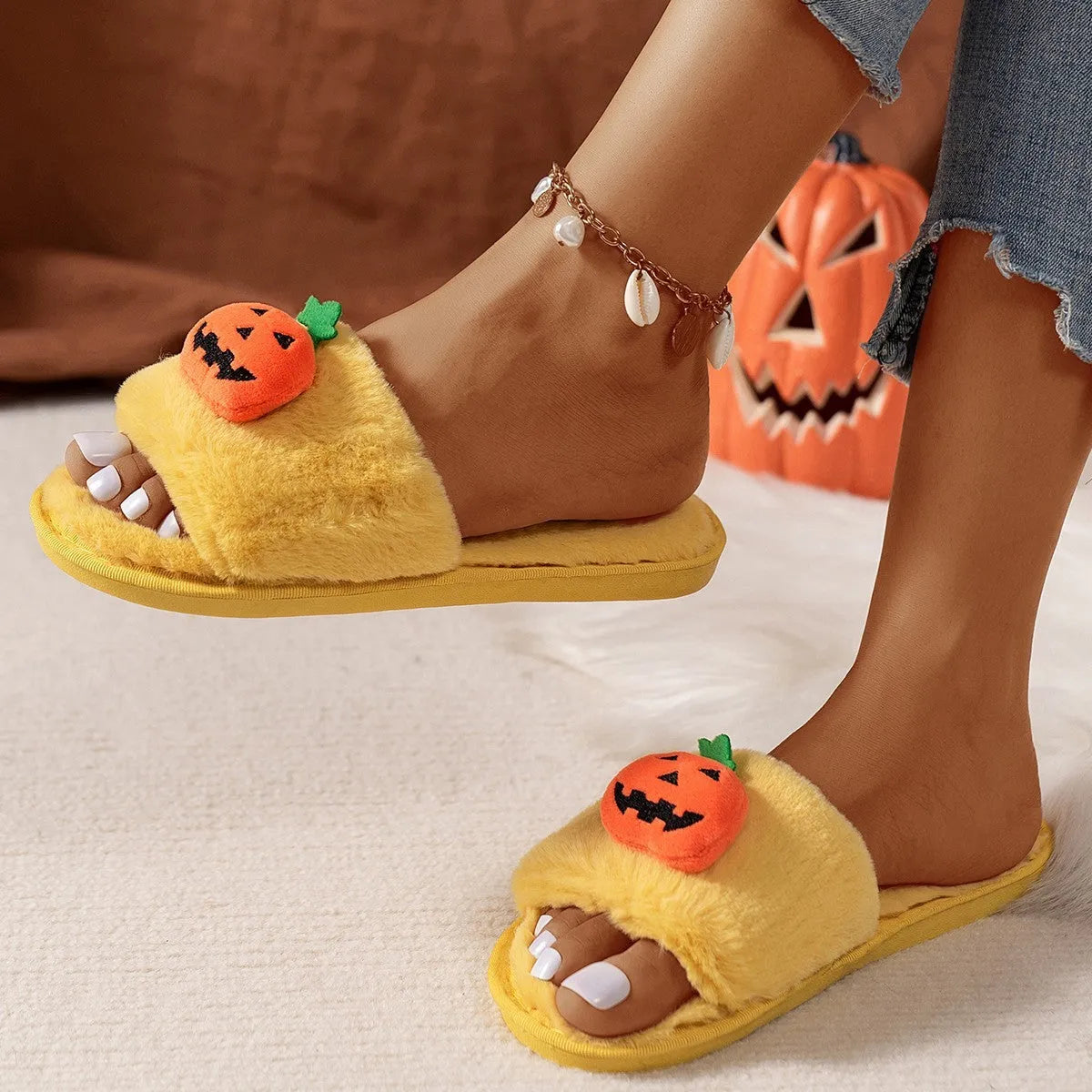White and yellow cartoon pumpkin plush open-toe slippers with a synthetic fur upper and PVC sole.