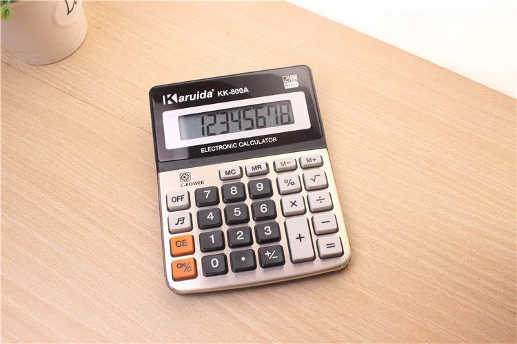 Silver aluminium desktop calculator with compact 14.5x11cm size on desk
