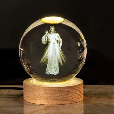 White crystal ball desk ornament on a wooden warm light base, showing purity-themed designs.