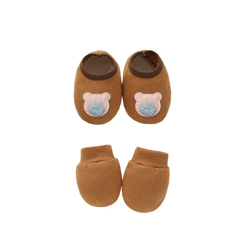 Set of white, light blue, and grey cotton baby pullover caps, gloves, and foot covers for infants.