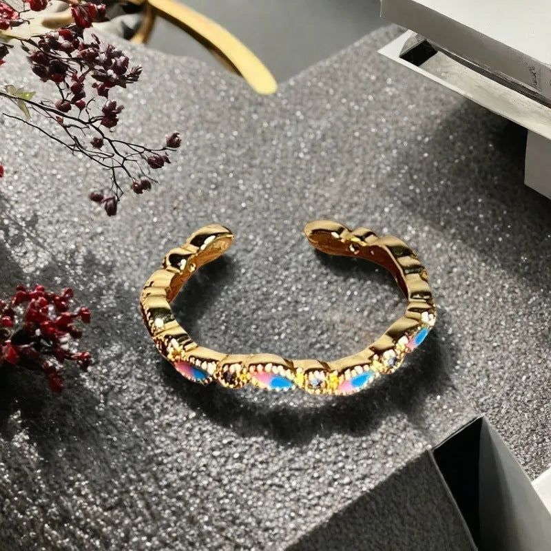 Close-up of a copper adjustable gourd ring with vintage oil-dripping finish and inlaid zircon stone.