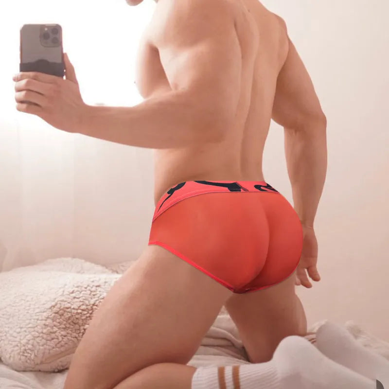 Men's solid colour modal boxer shorts in black, pink, and red with low waist design