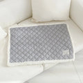 Quilted blue cloth pet blanket for cats, shown on a pet bed.
