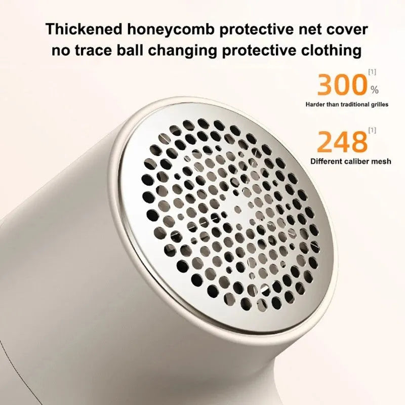 White electric lint remover with LED display and USB charging port on a fabric surface.