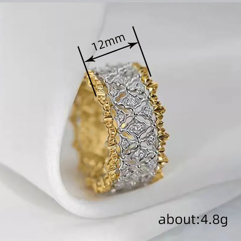 Gold two-tone geometric copper zircon ring on a plain background.