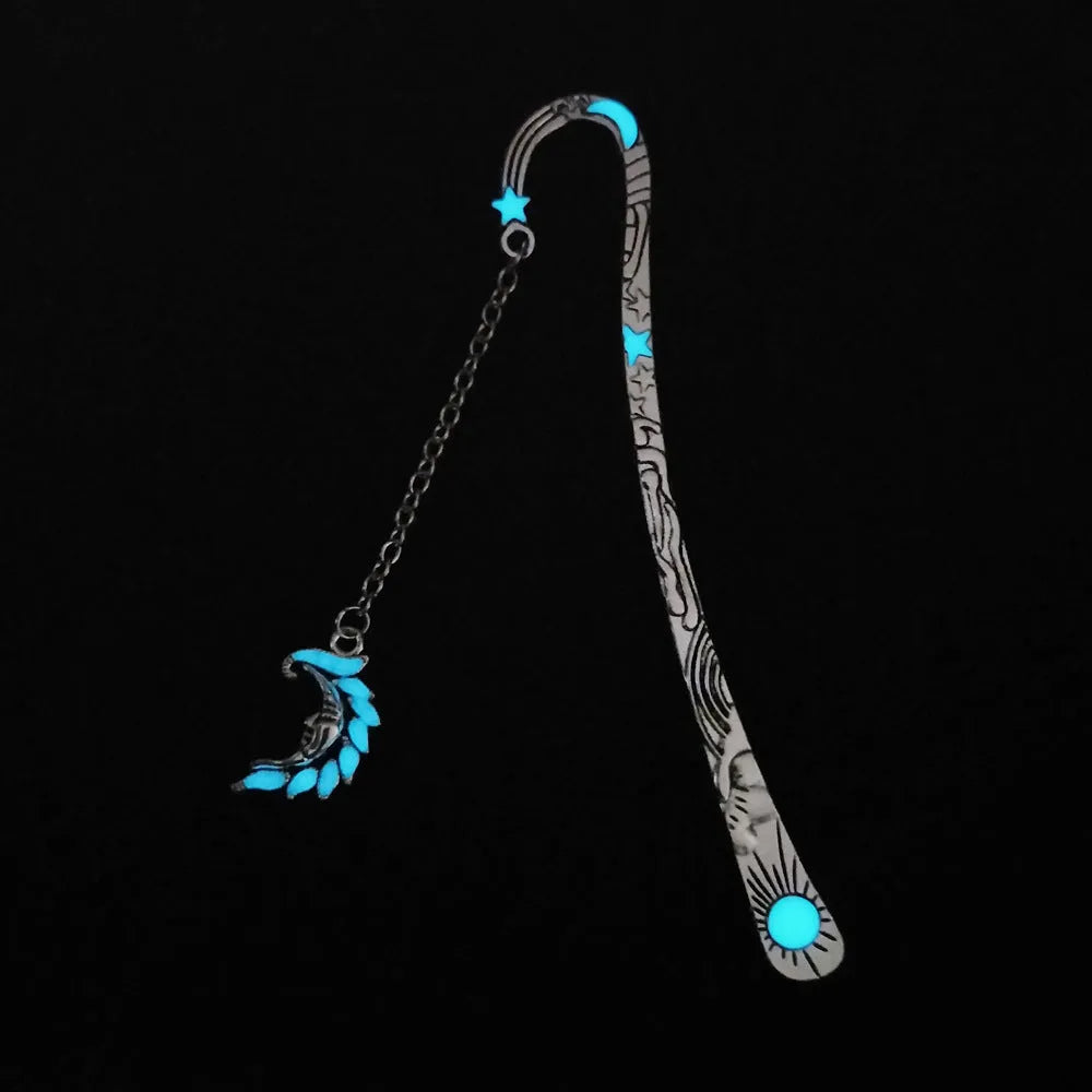 Metal bookmark with glowing five-pointed star and celestial sun moon stars design