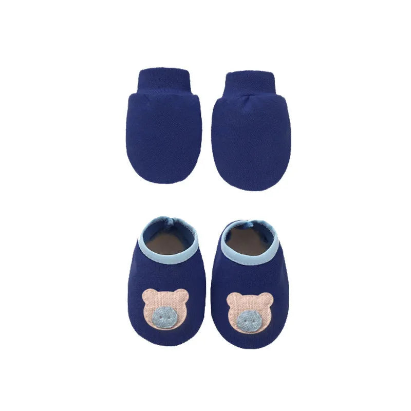 Set of white, light blue, and grey cotton baby pullover caps, gloves, and foot covers for infants.