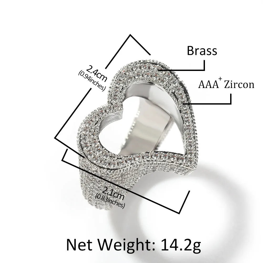 Gold copper ring with hollow heart cut-out and zircon stone on finger