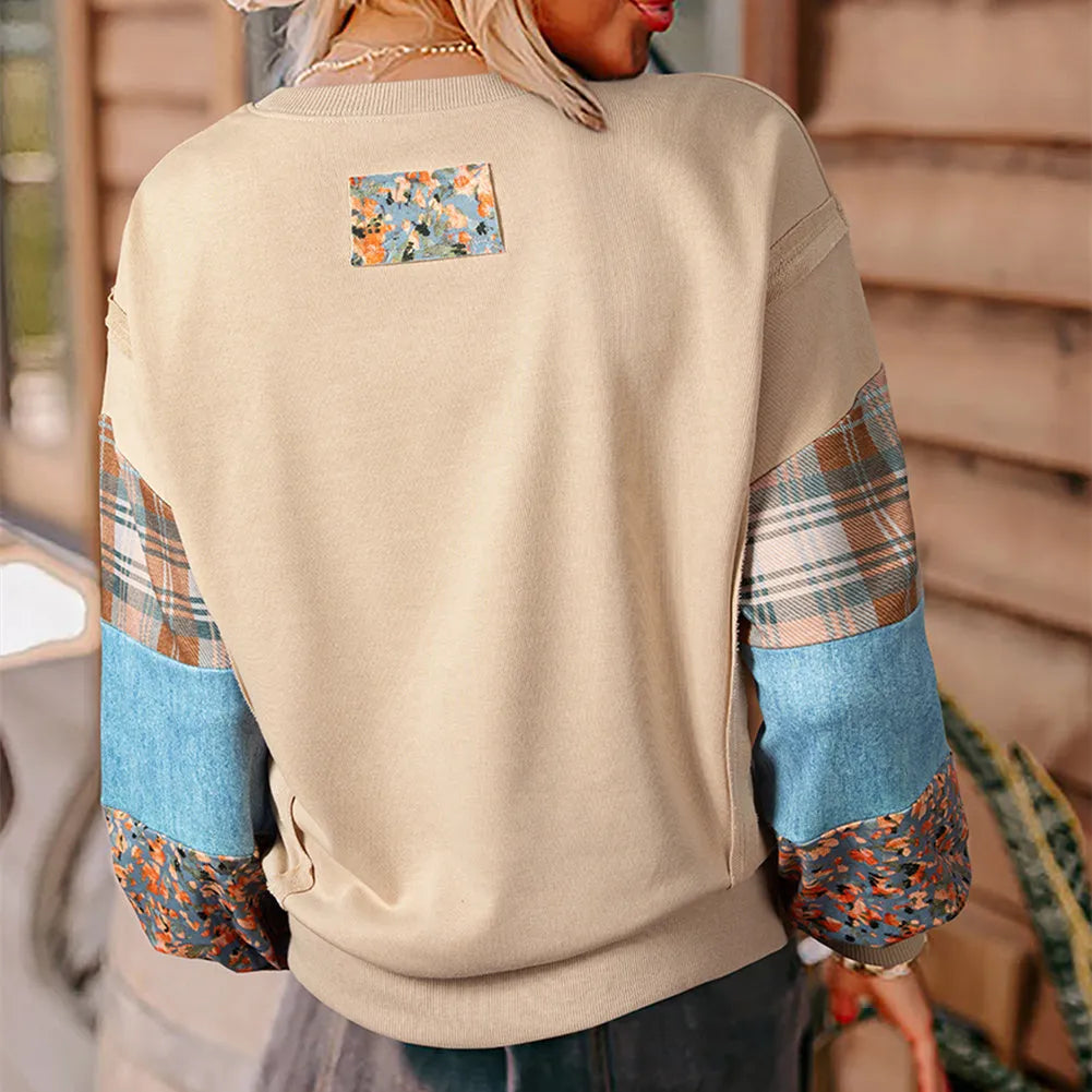 Women's loose fit apricot plaid stitch long sleeve pullover top on hanger.