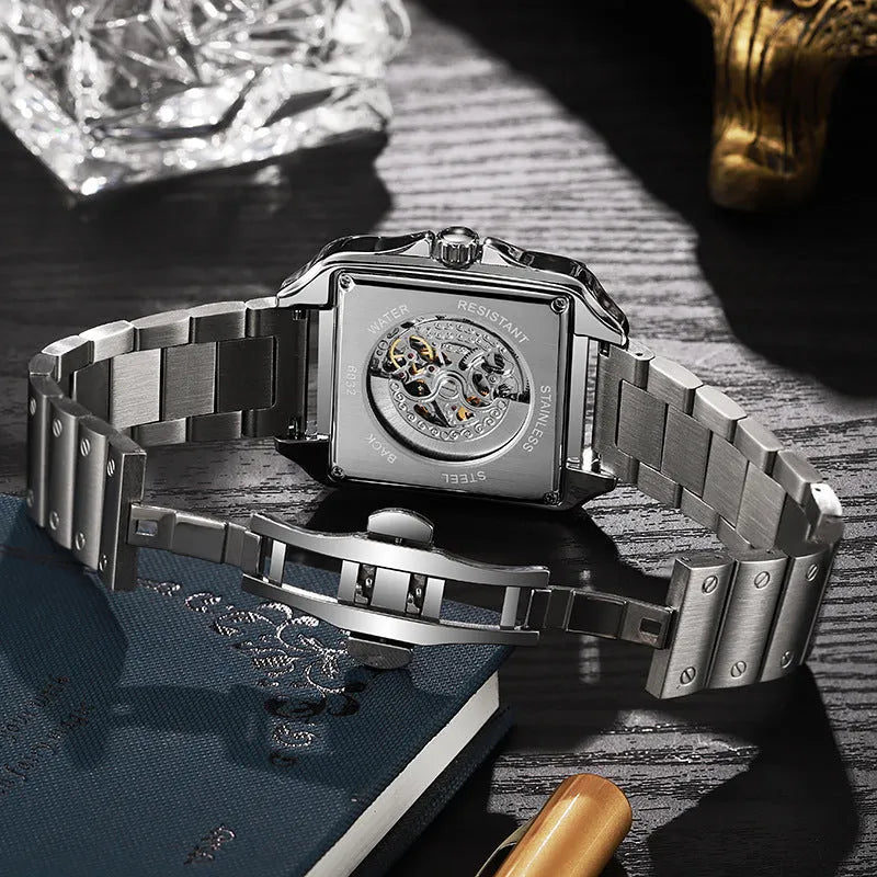 Men's square automatic watch with diamond-studded case on a black leather strap.