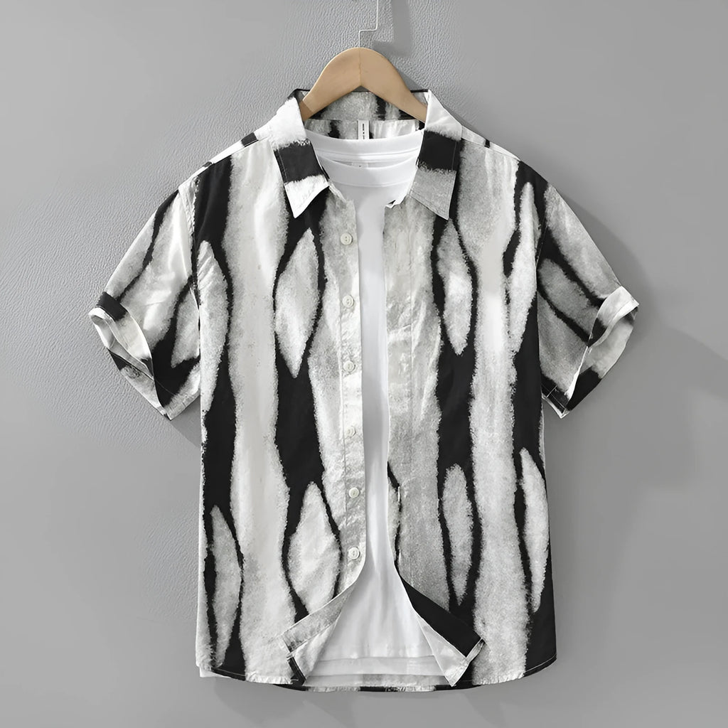 Man wearing a black and white retro striped short sleeve loose-fit cotton shirt.