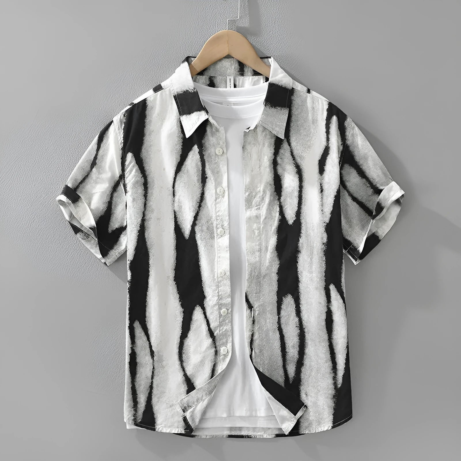 Man wearing a black and white retro striped short sleeve loose-fit cotton shirt.