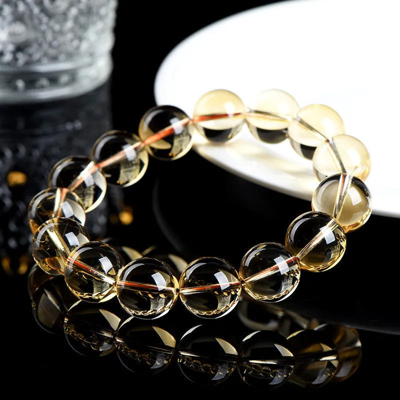 Adjustable natural citrine scattered beads bracelet on a wrist, showing polished yellow gemstones in an organic pattern.