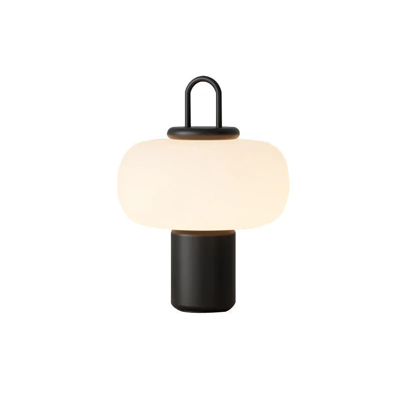 Minimalist Japanese glass bedside table lamp with warm light for a child's bedroom.