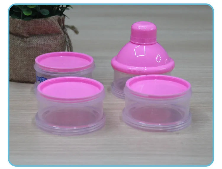 Blue and pink cartoon style plastic baby feeding set with bottle, bowl, bubble box and suction cup.