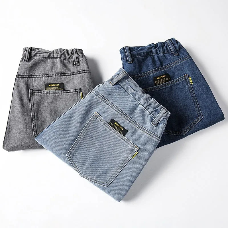 A pair of men's loose-fitting straight-leg casual jeans in dark blue cotton fabric.