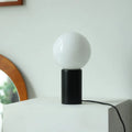 Retro bamboo and glass cylinder table lamp with button switch and USB port on bedside table